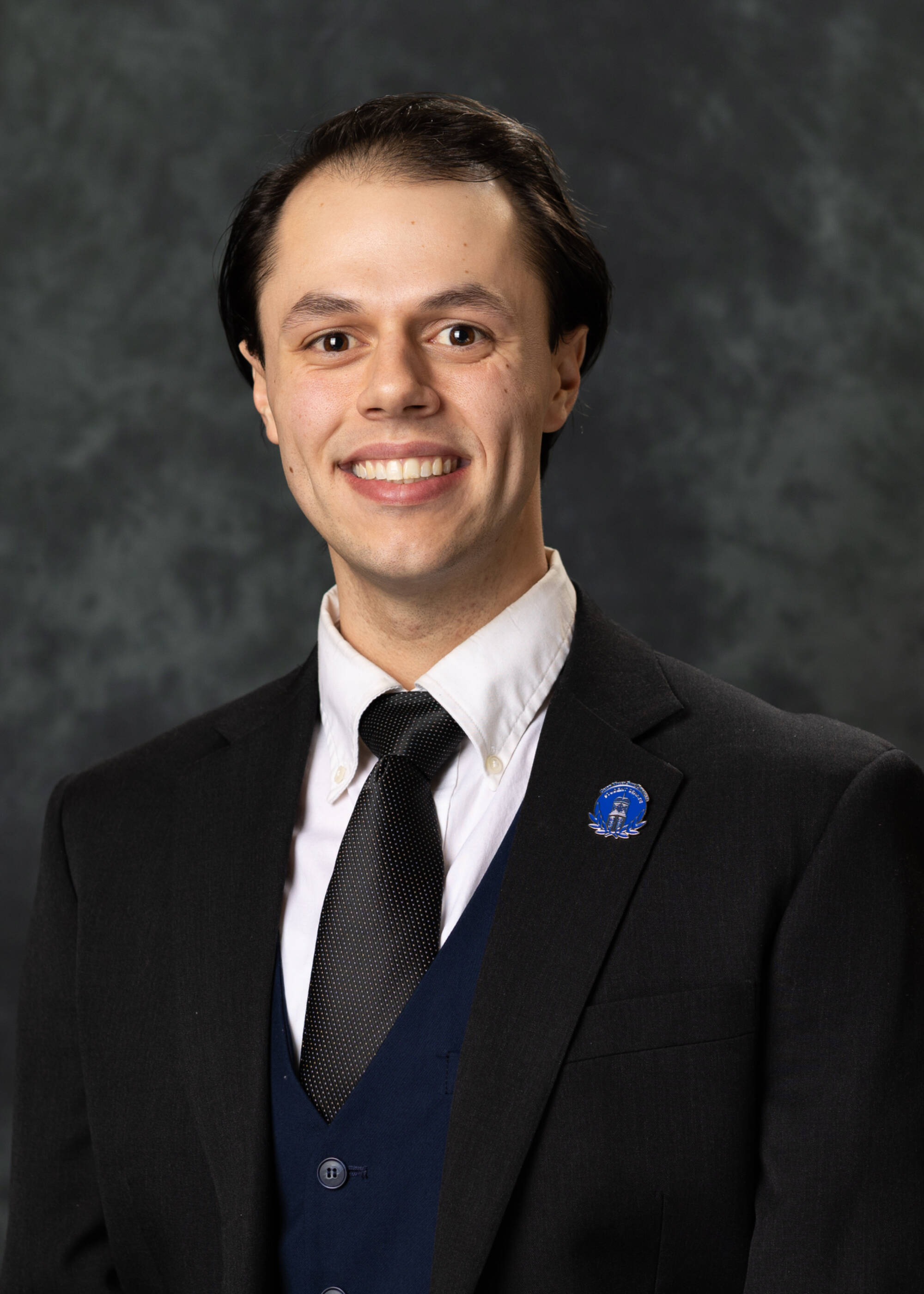 Andy Hardgrave smiling in a suit